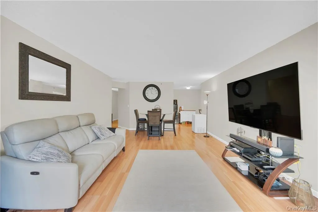 Long living room at 25 Rockledge Avenue #302 in White Plains, open to the dining area