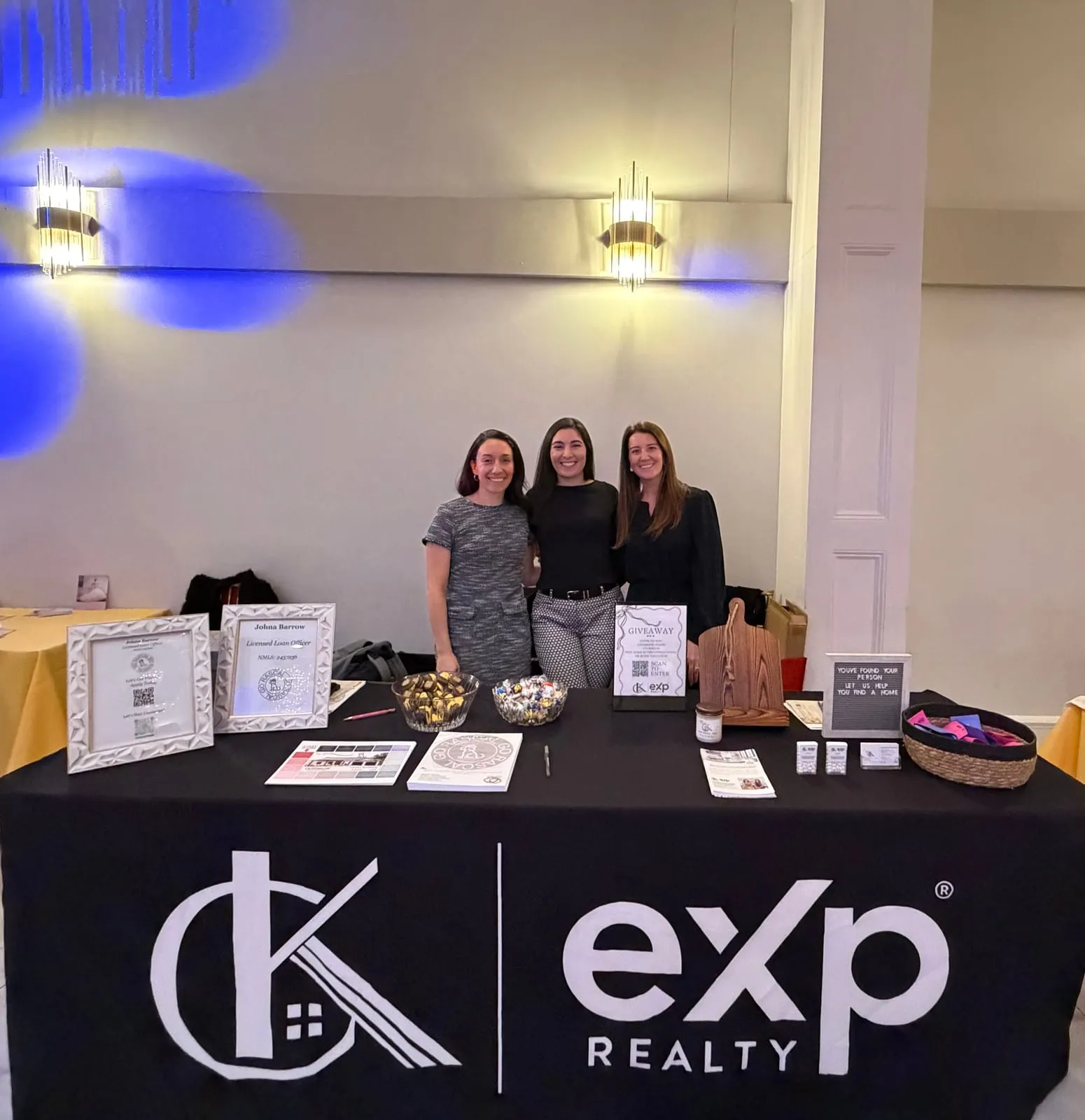 The CK Team and Johna from GoRascal at a CK Team and eXp Realty booth at a bridal expo