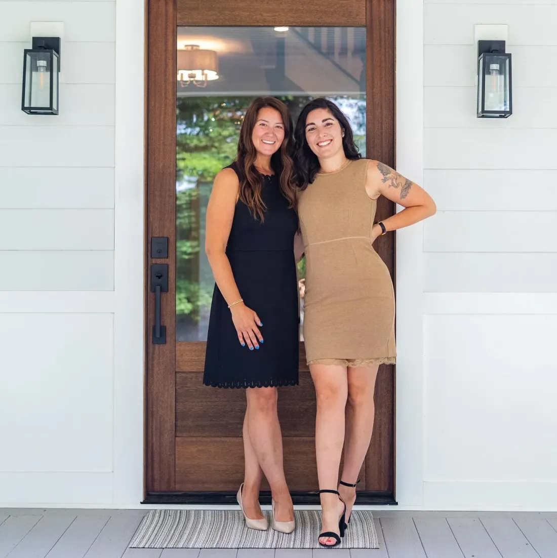 Kayleigh and Catia of The CK Team standing together at a home's front door