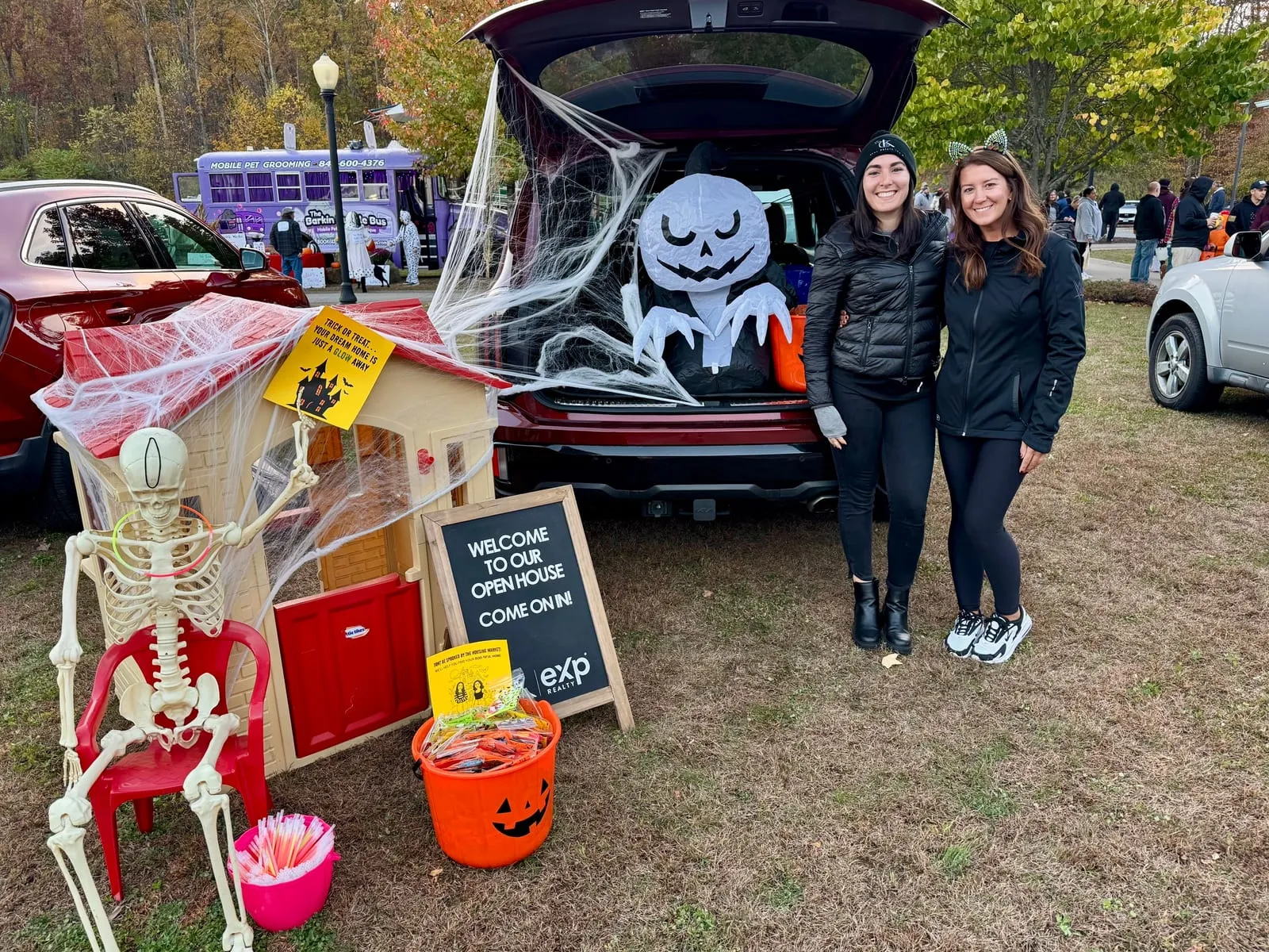 Two team members beside a decorated trunk and skeleton display at Kent Town Hall