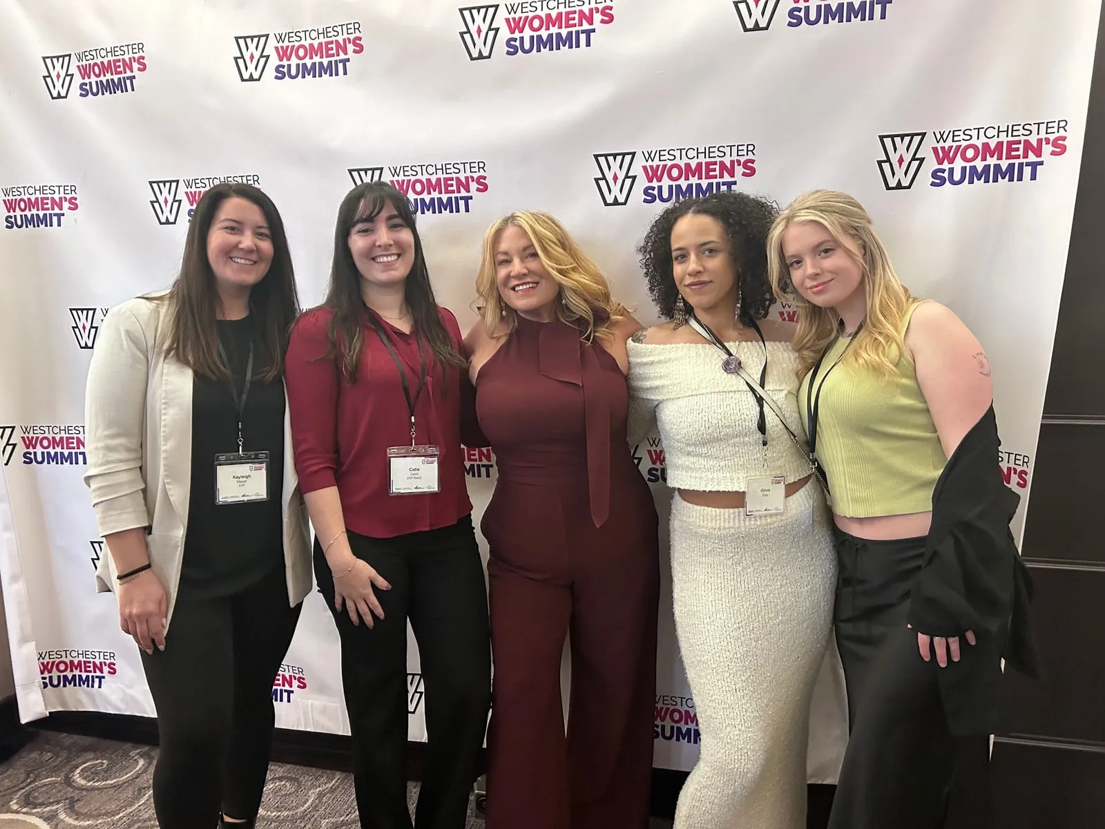 Five women in front of the Westchester Women’s Summit backdrop